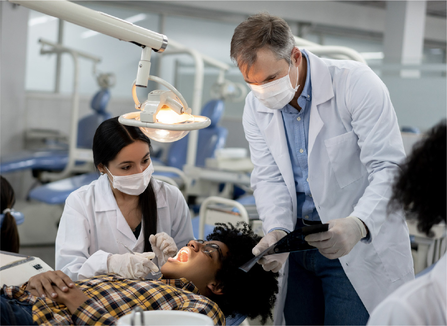 dental professionals evaluate a patient